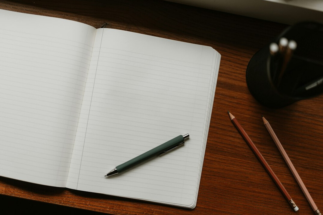 mystery writer at desk with notebook