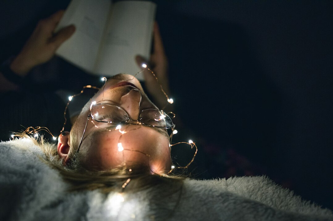 person reading mystery novel at night